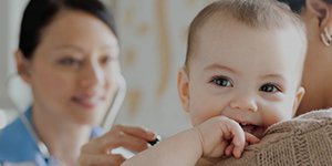 happy-and-smiling-baby-being-examined-by-a-doctor