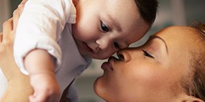 mom-kissing-her-happy-baby